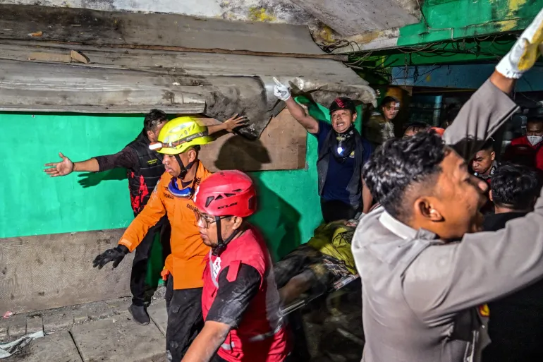 Rescue workers search through rubble after Islamic school collapse in Indonesia